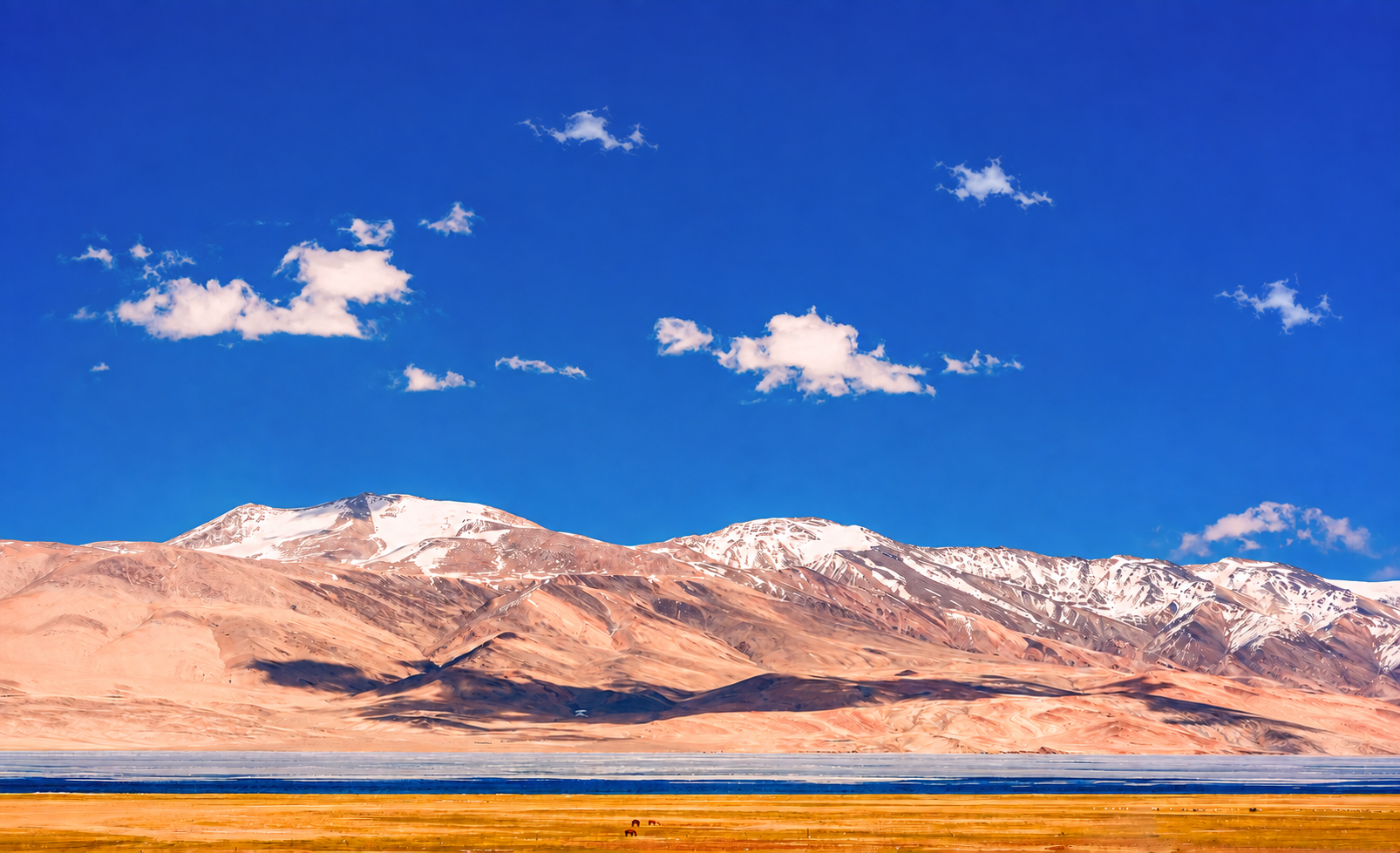 Snow-capped mountains beneath a clear blue sky