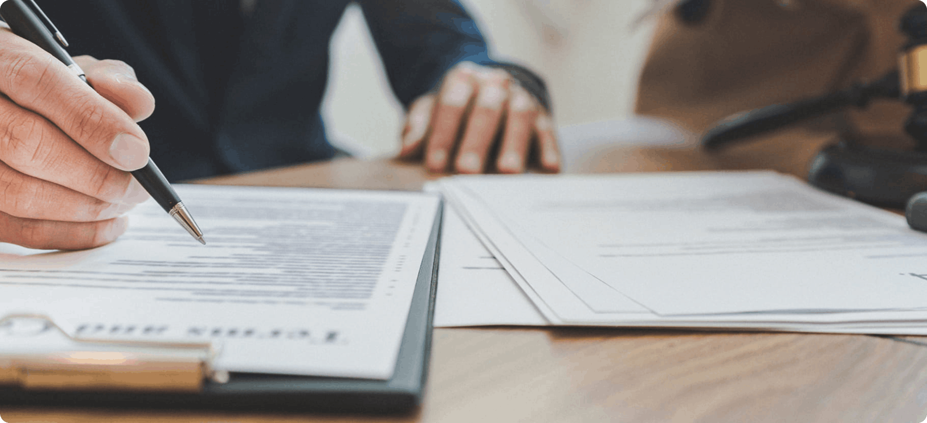 A professional writing on a legal document